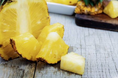 pineapple of cut on wooden background.の写真素材