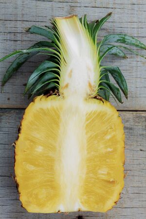 Ripe pineapple of cut on a wooden.の写真素材