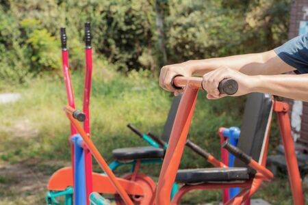 Hand held fitness machine in a park.の写真素材