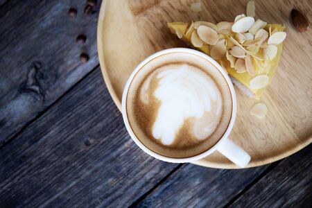 Coffee cup on tray with wooden background.の写真素材