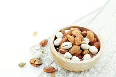 Almond in bowl on a white background.の写真素材