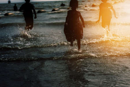 children with sunset at the sea.の写真素材