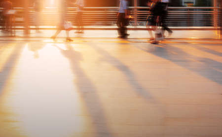 People are walking at sunset with blur image.の写真素材