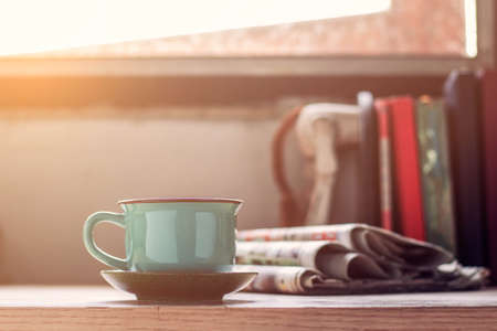 Cup of coffee and newspaper on the desk.の写真素材