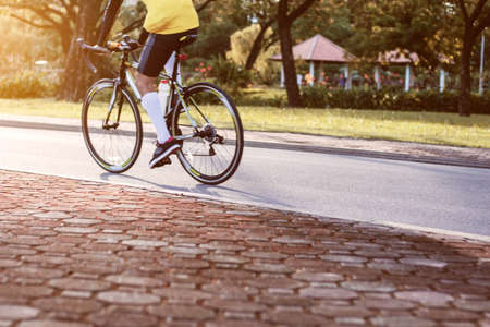 People are cycling with sunlight in the park.の写真素材