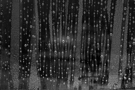 Water drops on glass in rainy season with black and white images.の写真素材