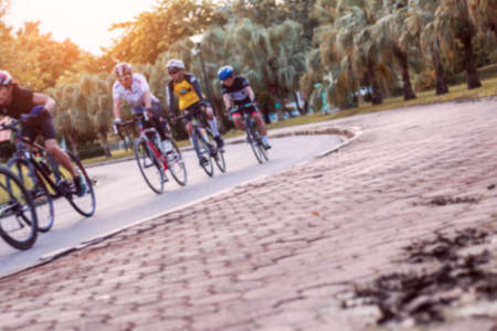 People are cycling on the roadside in park.の写真素材
