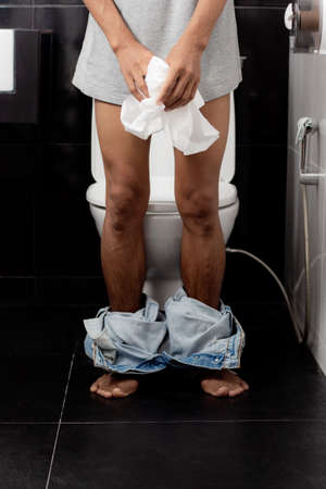 Men are standing in toilet at home.の写真素材