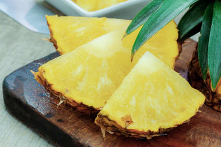 Pineapple ripe of slices on wooden floor.の写真素材