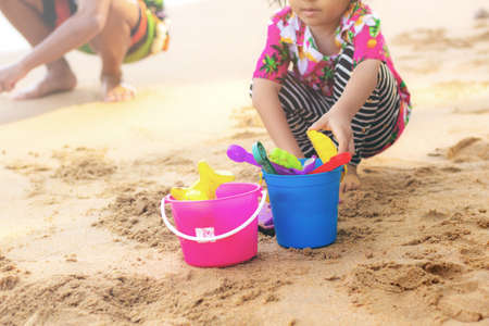 Girl are playing a toy on sand beach.の写真素材