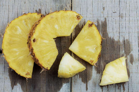 Pineapple cut of wet on a wooden background.の写真素材