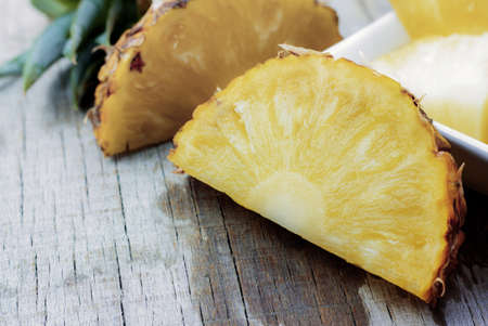 Pineapple ripe of cut on wooden background.の写真素材