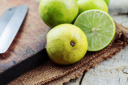 Lemon slice half and knife on table.の写真素材