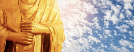 Hands of Buddha in Thailand with the sky.の写真素材
