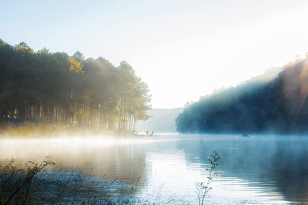Water of lake at sunrise and the cold fog in the winter.の写真素材