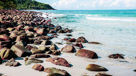 Rocks on sand beach with the sunlight.の写真素材