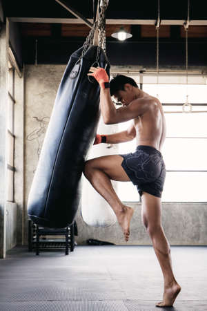 Muaythai kickboxing of punching bag in boxing stadium.の写真素材