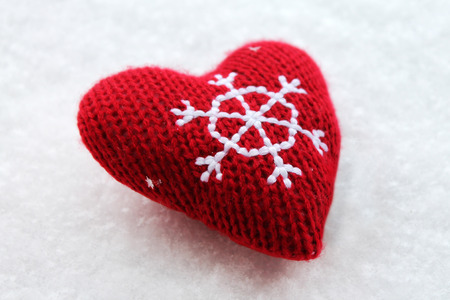 Red Christmas heart on the snowの写真素材