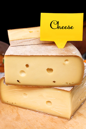 Cheese for sale with tag at a marketの写真素材