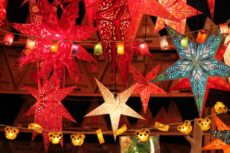 Colorful Illuminated Christmas Stars For Sale At Market. Traditional germany decoration.の写真素材