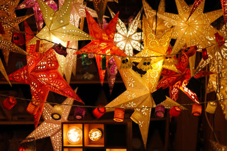 Colorful Illuminated Christmas Stars For Sale At Market. Traditional germany decoration.の写真素材