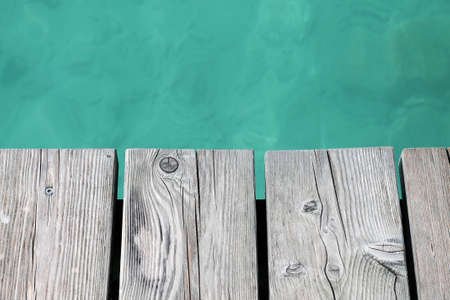 Lake background with empty wooden pier.