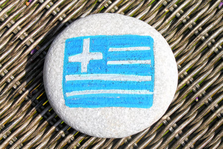 Greece country name painted on the stones on wicker desk background.の写真素材
