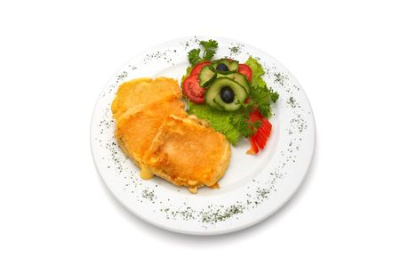 deep fried cheese in egg, with fresh vegetables, served on plate.の写真素材