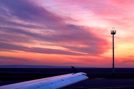 Sunset at airfield (coudscape and aircraft wing). の写真素材