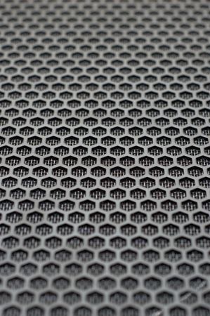 background of hexagonal pattern of speaker grille. selective focus.の写真素材
