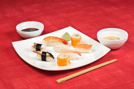 assorted sushi lying at the white square plateの写真素材