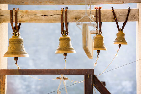row of church bells on wooden beamの写真素材