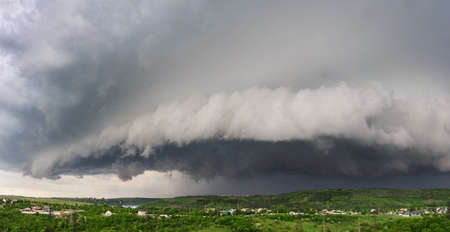 Beginning of the storm, cold weather front covers the village. Panorama stitched from 4 mages.の写真素材