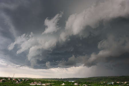 Beginning of the storm, cold weather front covers the village. Panorama stitched from 4 mages.の写真素材