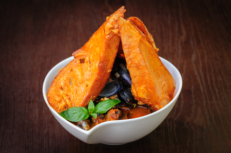 mussel soup with toasted breadの写真素材