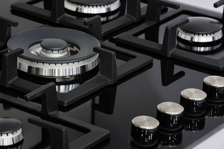 Modern clean brand new gas stove with black glass trayの写真素材