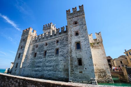 Sirmione, province of Brescia, Lombardy, northern Italy, 15th August 2016: people visiting the medieval castle Scaliger on lake Lago di Gardaのeditorial素材
