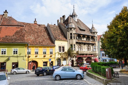 Sighisoara, Romania - October 19th, 2016: View of modern streets with people and cars in historic center of Sighisoara, Transylvania region, Romaniaのeditorial素材