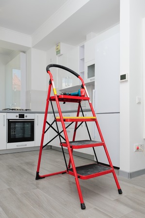 Modern white kitchen at stage of finishing, minimalistic clean design