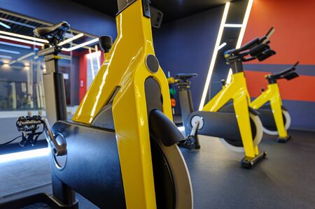 Modern spinning class, gym with indoor bikes in a rowの写真素材