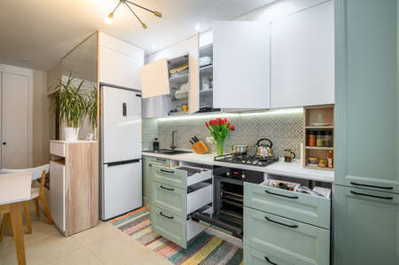 Cozy modern kitchen interior, some drawers pulled outの写真素材