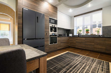 Modern luxury large dark brown, gray and black kitchen details