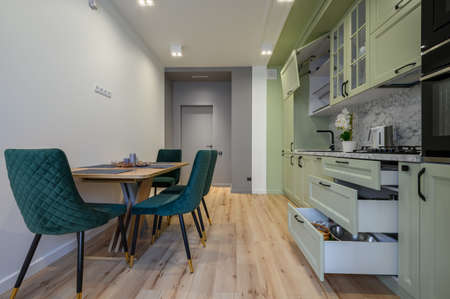 Modern light green luxurious kitchen with dining tableの写真素材