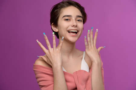 Cute girl with short haircut and extravagant nail artの写真素材