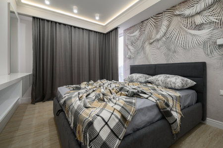 Stylish interior of bedroom with comfortable bed