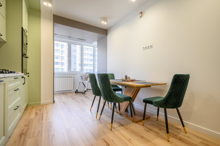 Modern light green luxurious kitchen with dining table