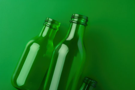 Two green glass bottles sitting next to each other. AI generative imageの素材
