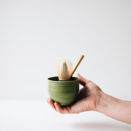 Preparing of matcha green tea. A person holding a green bowl with a whisk in it. AI generative image.の素材
