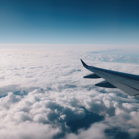 The wing of an airplane flying above the clouds. AI generative image.の素材