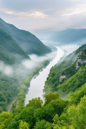 A river running through a lush green valley. Generative AI image.の素材